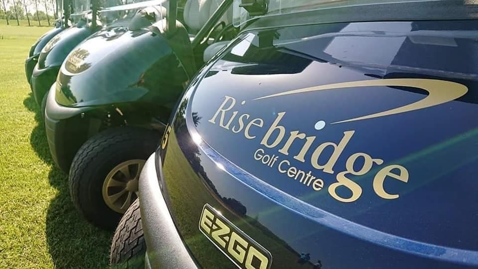 Navy Risebridge buggies lined up, the club's name in gold on the front