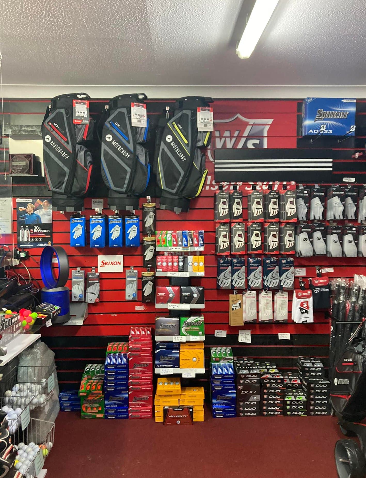 The pro shop wall: bags, gloves and boxes of balls