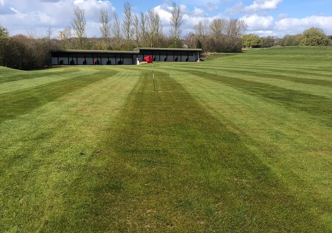 Looking back from the range outfield towards the bays, mowing stripes in the grass