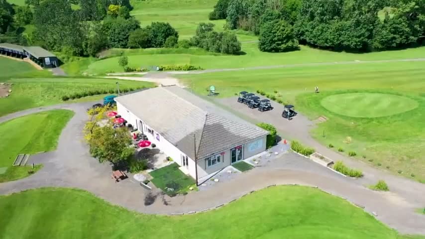 The clubhouse from the air, with the putting green and car park